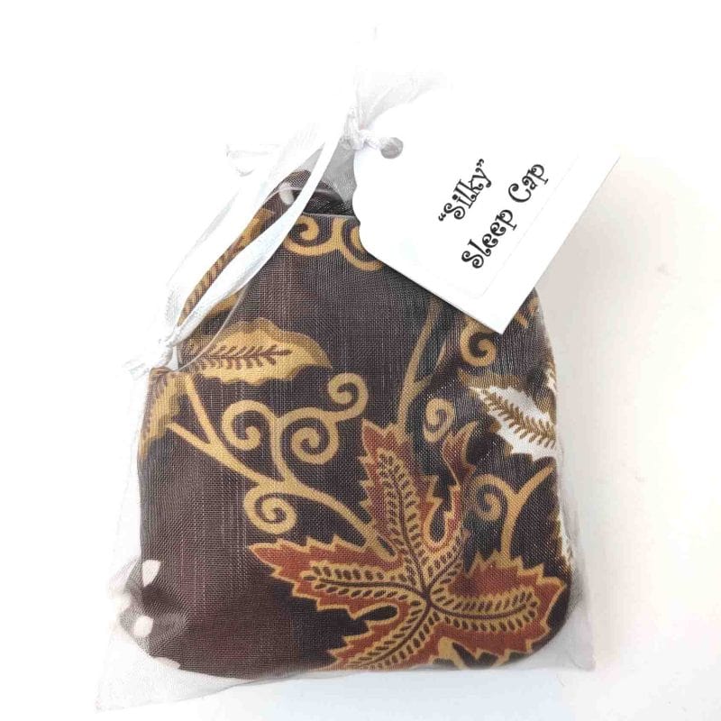 silk sleep cap with chocolate background with light brown leaves in a see through bag