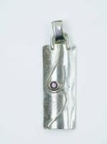 Sterling Silver Pendat with Garnet (1) This pendant is made from sterling silver and set with a garnet in a deep red shade.