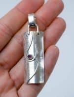 Sterling Silver Pendat with Garnet (2) This pendant is made from sterling silver and set with a garnet in a deep red shade.