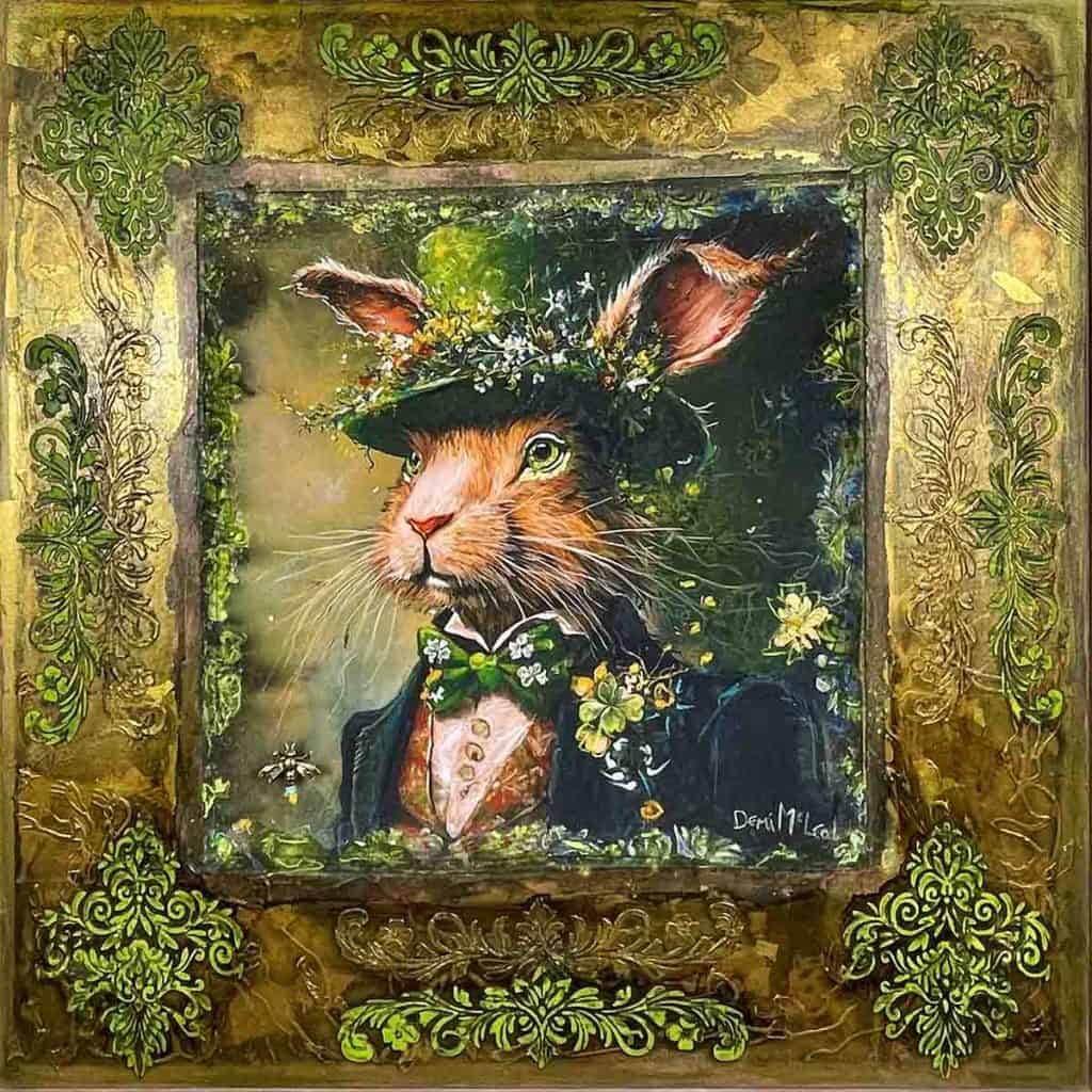 an orginal mixed media artwork by local western australian artist Demi Mcleod featuring a rabbit with a hat on with flowers coming out of the top of the hat. Vibrant gold and green lace around the border.