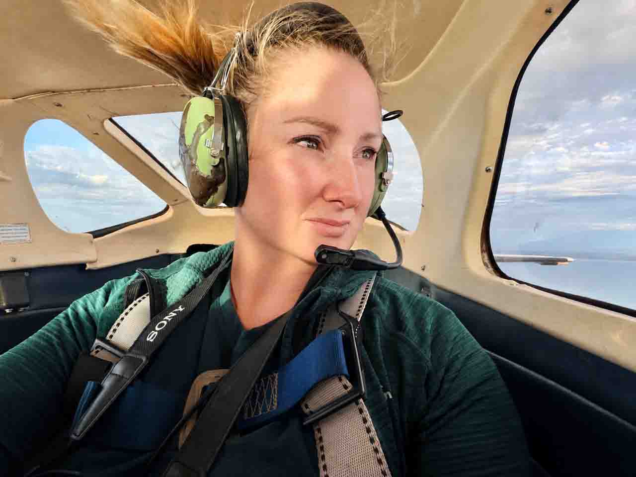 Julie Kenny Aerial Photographer in front passenger seat of plane