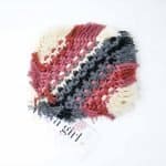 A square macramé drink coaster featuring alternating rows of rose, charcoal, and ivory cotton cord with fringed edges. The coaster is displayed on a white background with a WA Girl tag tucked underneath.