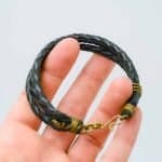 Oswaldo Paz multi strand leather bracelet A black braided leather bracelet with brass wire wraps and a hook clasp by Oswaldo Paz local Fremantle Artisan
