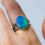 Australian Solid opal ring, oval shaped sterling silver band on a fore finger handcrafted by Roger Withers