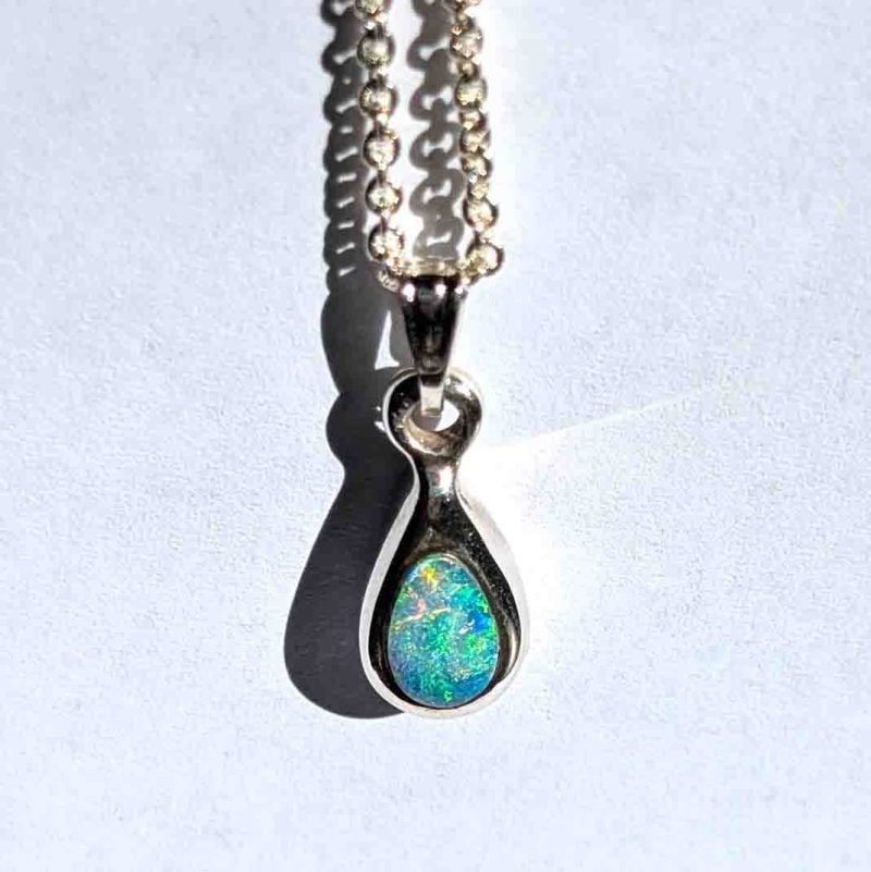 Pear shaped solid opal and chain showing beautiful play of colour handcrafted by Roger Withers