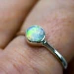 Green+Yellow opal in sterling Silver (2) A close-up photo of the ring worn on the same finger.
