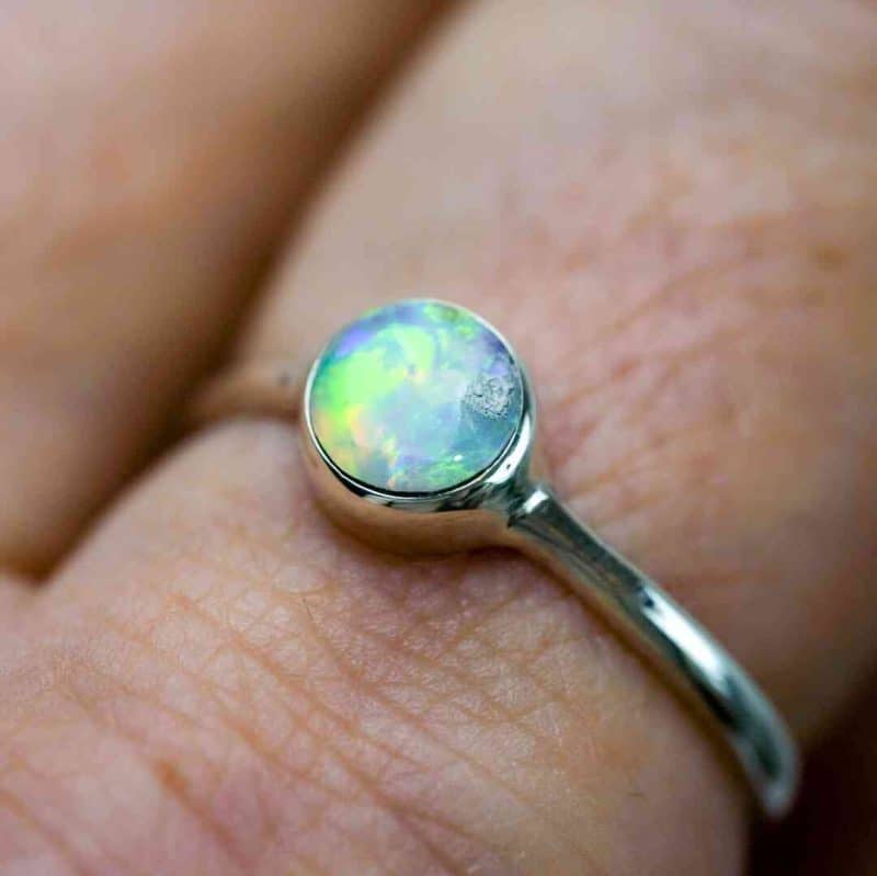 A close-up photo of the ring worn on the same finger.