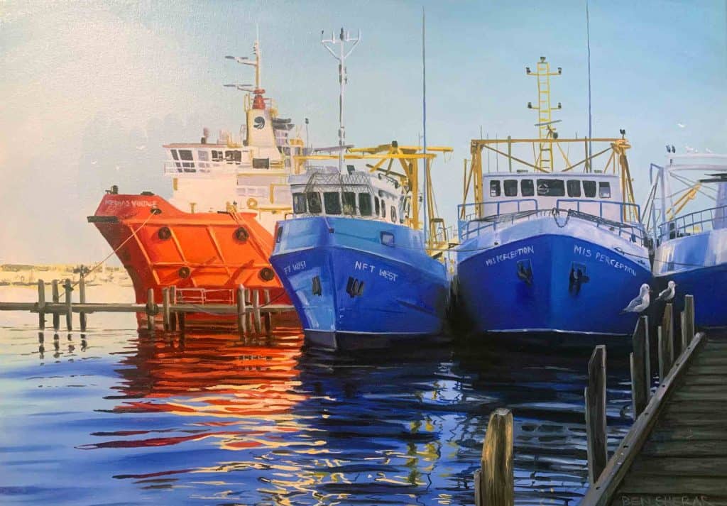 An oil painting of large fishing vessels docked side-by-side at Fremantle Fishing Boat Harbour, featuring a bright orange ship on the left alongside two vibrant blue boats named "Net West" and "Mis Perception," all casting colorful reflections across the calm harbor water.