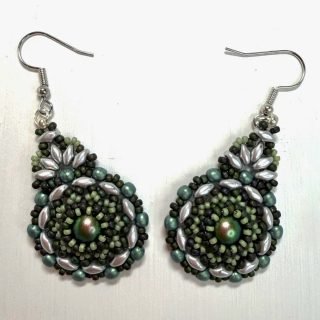A pair of green earrings on a white background. The earrings are circular and made from intricate beading