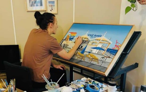 Laura Farnhill in her studio painting Gage Roads