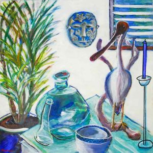 Colourful still‑life painting showing a tabletop arrangement with a potted plant, glass bottles, a patterned ceramic bowl, and a sculptural bird figure beside a blue candle. A decorative blue mask hangs on the wall above, with a window featuring blue shutters in the background. The composition uses expressive brushstrokes and vibrant blues, greens, and purples