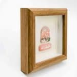 Winimum Handmade -Mt Jade Side view of a small framed artwork depicting Mt Jade, Taiwan’s tallest peak. The piece features a handcrafted polymer clay sculpture showing rugged mountain ridges beneath a pink and orange sky. The artwork is encased in a wooden shadow‑box frame with a glass front, highlighting its depth and fine craftsmanship against a plain white background.