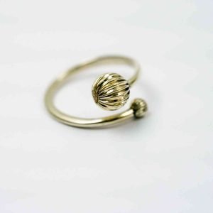 A silver ring in an open design, the ring is adjustable with asilver decorative ball on either end.