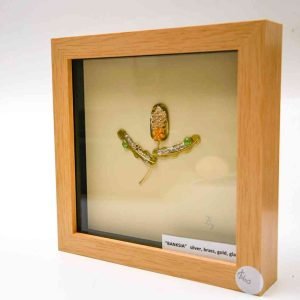A slightly side-on view of the framed banksia sculpture shows the thick frame