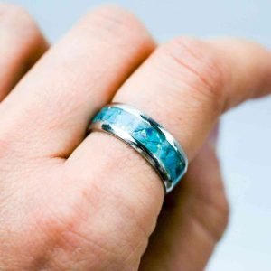 A ring made from sterling silver inlayed with blue chrysocolla and opal.