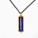 Lapis Lazuli Pendant Felicity Peters (4) A rectangular pendant hangs from an oxidised silver chain. The pendant is made of a delicate gold frame housing a large piece of lapis lazuli