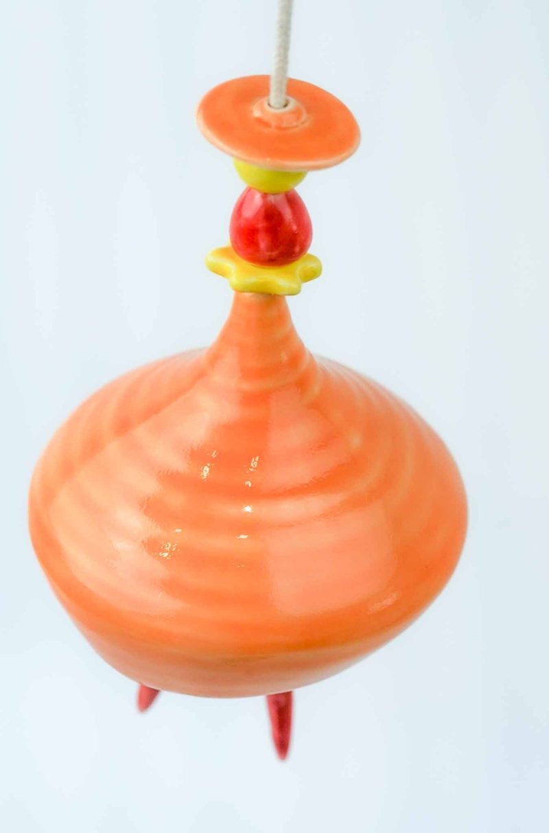 A zoomed out picture of the ballerina from an upwards angle, showing the inset lines on her skirt from the ceramic creation process.