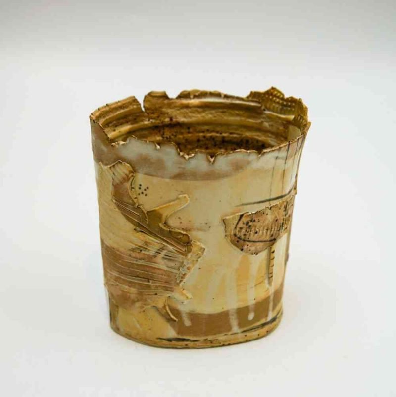 The sand-toned stoneware vase sits alone on a white background