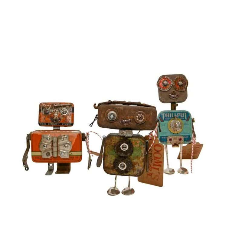 Three small robot sculptures made from vintage tins, bolts, and wires arranged together on a white background.