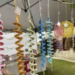 Emily Mcrea windspinners hanging at a market stall