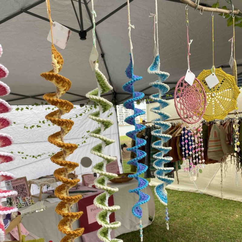 wind spinners crochet Emily Mcrea windspinners hanging at a market stall